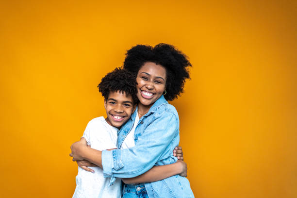istock Portrait of siblings on orange background 1424873820