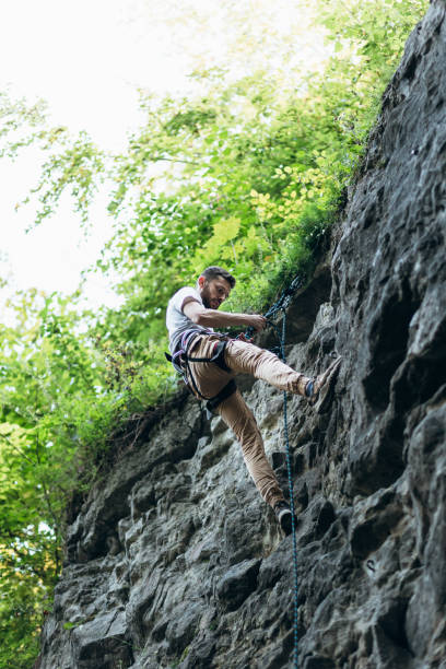 istock The man climbing on the rocks 1424873994