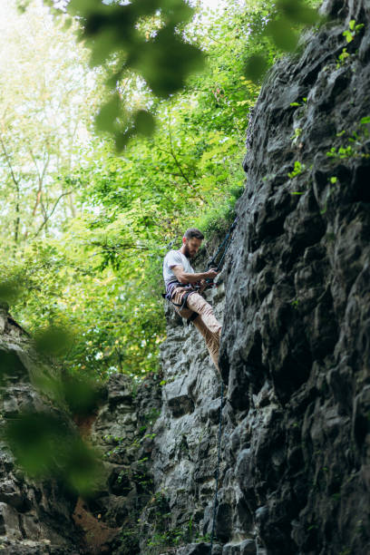istock The man climbing on the rocks 1424874032