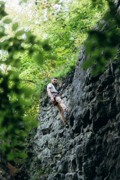 istock The man climbing on the rocks 1424874061