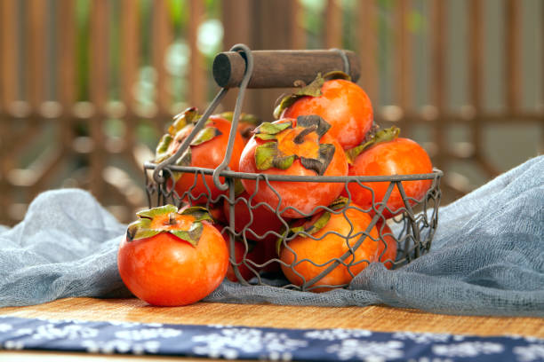 istock Fresh persimmon by the wooden window 1424876386