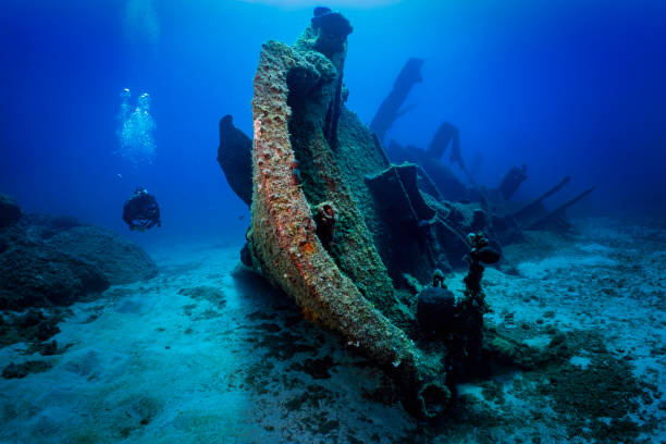 A scuba diver explores a shipwreck at the seabed of Patroklos island A scuba diver explores a sunken shipwreck at the seabed of Patroklos island, Greece bottom the weaver stock pictures, royalty-free photos & images