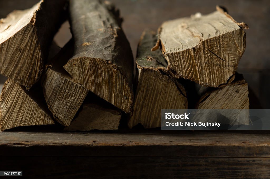Logs of firewood for a firebox on a wooden texture Brown Stock Photo