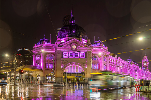 Melbourne, Australia - September 18, 2022: The facade of Flinders Street Station is lit in purple to honour the late Queen Elizabeth II.