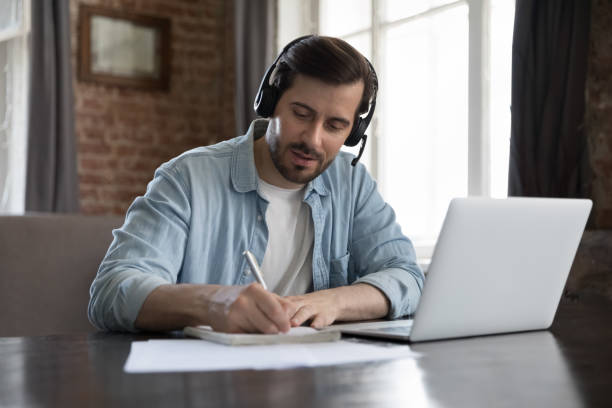 istock Busy employee man in wireless headset talking to client 1424880440