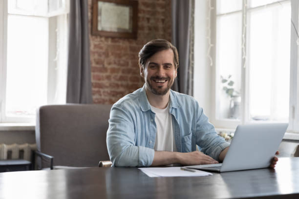 istock Happy successful business leader man sitting at work table 1424880459