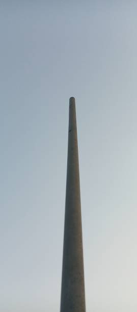 istock A towering iron pillar against a blue sky background. 1424883581