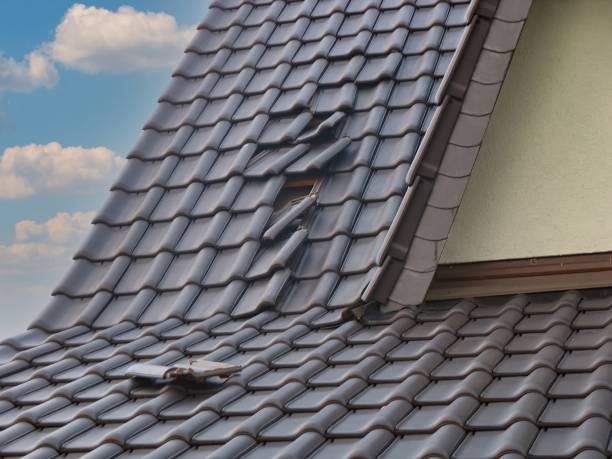 Storm damage - slipped roof tiles after hurricane stock photo