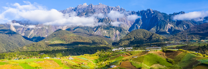 aerial view of Kundasang Sabah landscape with cabbage farm and Mount Kinabalu at far background during morning.