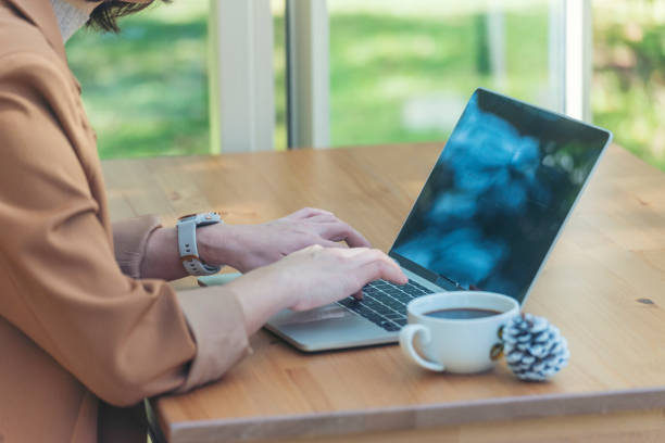 Close up businesswoman hand typing laptop drink black coffee cup in green garden cafe. Woman Hands love drinking hot coffee working from home. Business women with black coffee or hot chocolate cafe de cerca mujer de negocios escribiendo a mano computadora portátil beber taza de café negro en el café del jardín verde. a woman hands le encanta beber café caliente trabajando desde casa. mujeres de negocios con café negro o café de chocolate calie