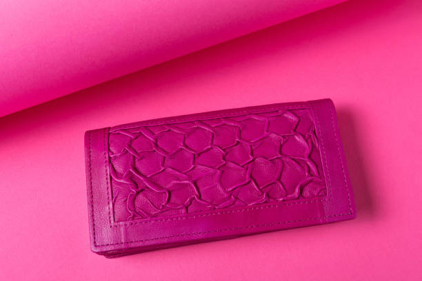 istock Lilac women's leather wallet with a textured finish, located on a pink background 1424891344