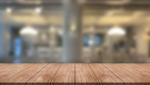 istock Empty wooden table top with lights bokeh on blur restaurant background. 1424894958