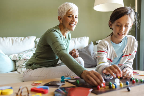 istock Playing board games with grandmother at home 1424896934