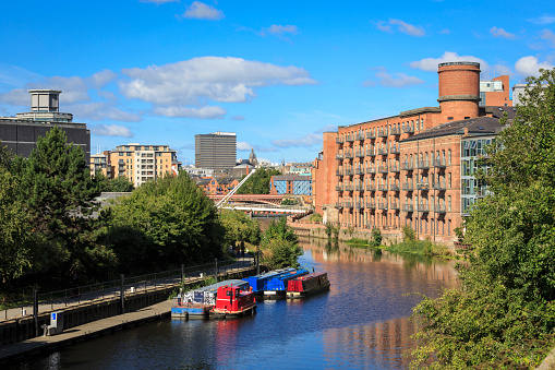 Apartments overlooking the river Aire and Leeds city centre, with Leeds Town Hall in the distance.