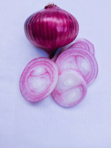 Onion bulb and pieces raw fresh organic redonion vegetable pieces for cooking or common onion shallot or allium cepa closeup view stock image photo