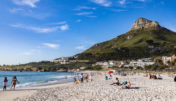 Cape Town, South Africa - September 14, 2022:  People of different races enjoy the beach at Camps Bay in Cape Town, South Africa.