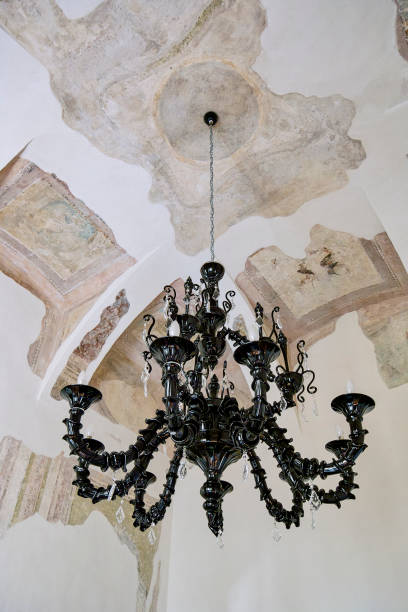 istock ancient black glass chandelier hanging on a frescoed ceiling 1424901555