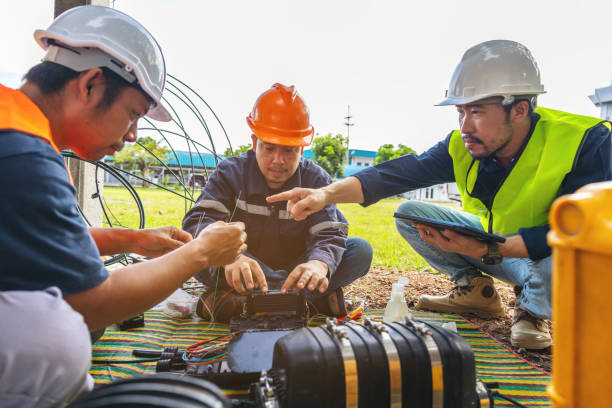 istock Fusion of Fiber Optics Cable Internet signal splicing and wire connection using equipment, optical line welding machine Optic fiber soldering ISP engineer 1424906904