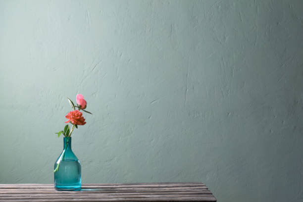 istock pink peonies in glass vase on green background 1424907200