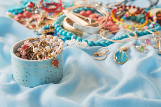 istock different women's jewelry on blue fabric 1424907387