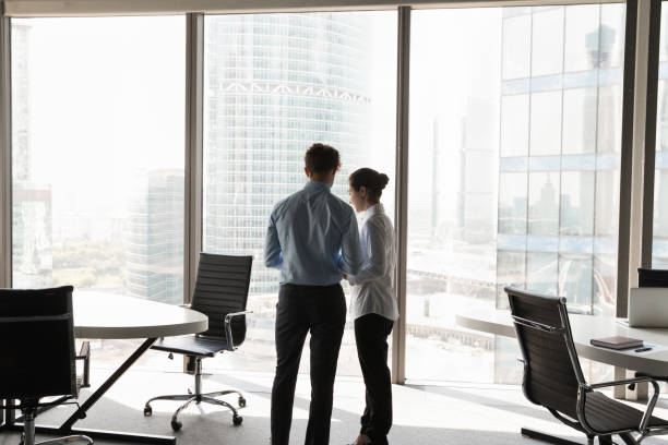 istock Two young diverse business colleagues talking in contemporary office 1424912306