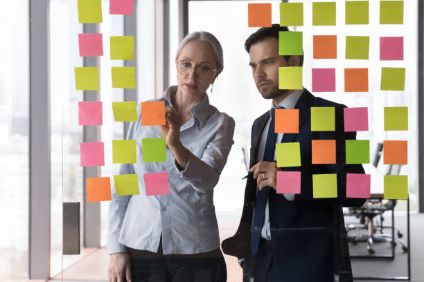 Two serious focused business colleagues working on project together