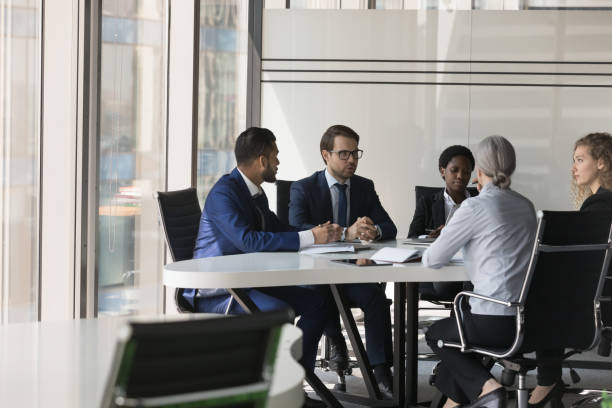 istock Serious diverse group of business coworkers collaborating on project 1424912523