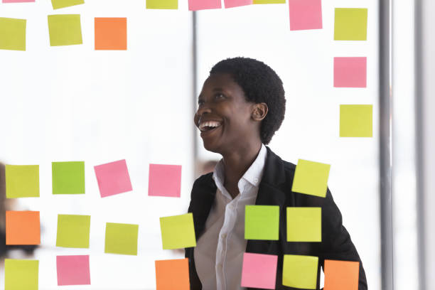 istock Cheerful successful African business woman making project schedule 1424912552