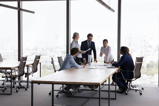 istock Young business leader speaking at project group in modern office 1424912944