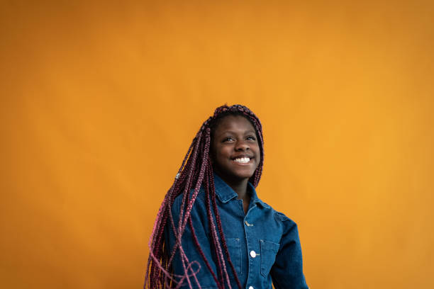 istock Girl looking away on an orange background 1424913494