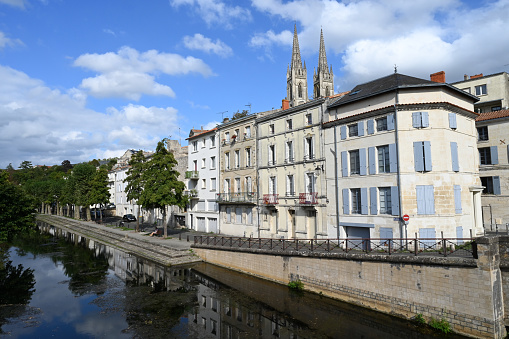 Quay bordering the Sevre Niortaise with the Saint-Andrew church in the background