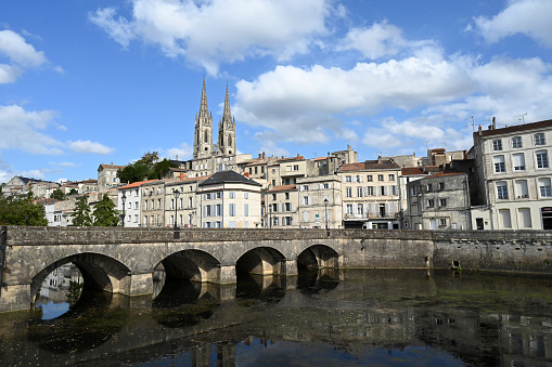 Bridge crossing the Sevre Niortaise river with the Saint-André church in the background