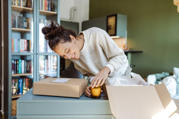 istock Woman opening online ordered items and holding product 1424927671