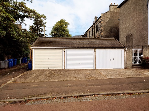 Car garages with door at street of glasgow scotland england uk