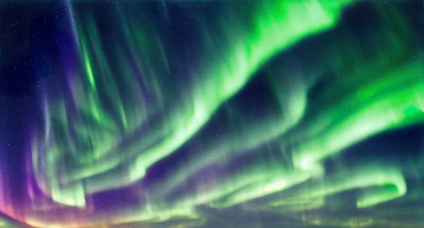 The northern lights aurora borealis over dark starry sky