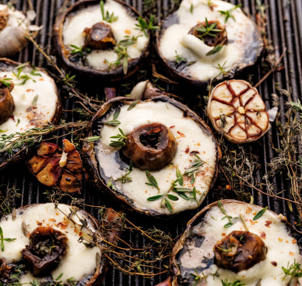 istock Grilled mushrooms with mozzarella cheese and herbs on a cast iron grill plate 1424935012