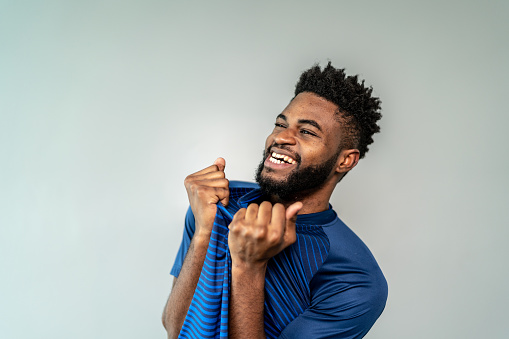 Male athlete / fan celebrating on blue uniform