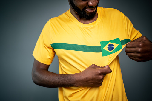 Male Brazilian athlete / fan showing his uniform
