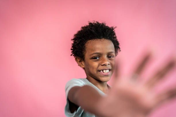 istock Portrait of a boy on a pink background 1424942540
