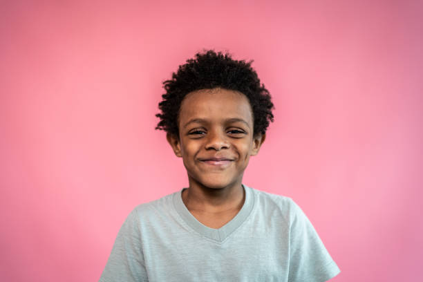 istock Portrait of a boy on a pink background 1424942547