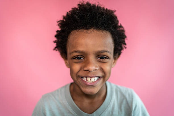 istock Portrait of a boy on a pink background 1424942548