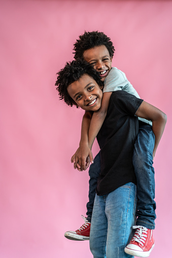 Portrait of brothers on a pink background