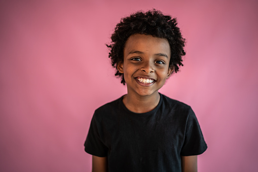 Portrait of a boy on a pink background