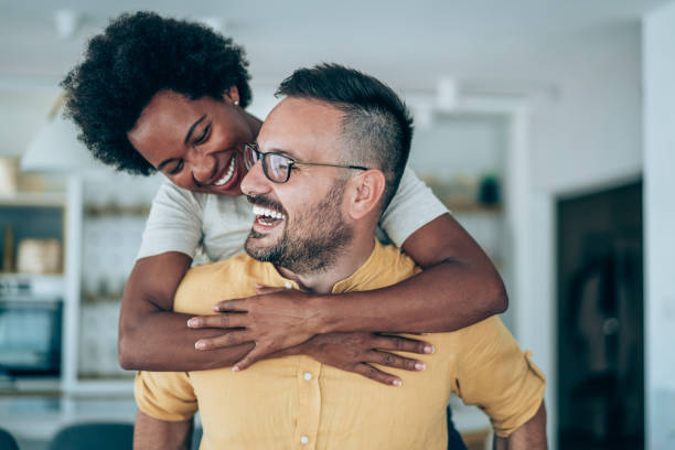 istock Young happy couple piggybacking at home. 1424945156