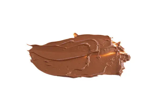 Chocolate cream spread on white background. Top view, isolated. Melted chocolate.