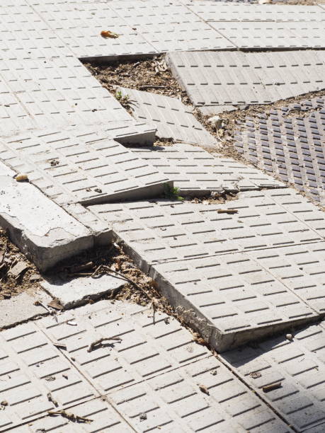 istock uneven sidewalk tiles. Potholes, insecurity and risk 1424949494