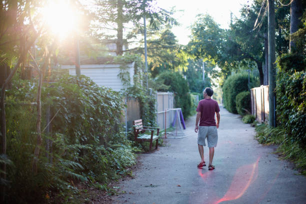 istock A man walks down an alley at sunset 1424949498