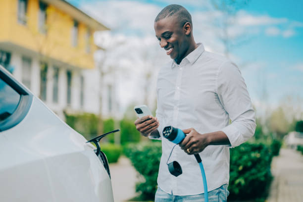 istock Man charging electric car 1424952413