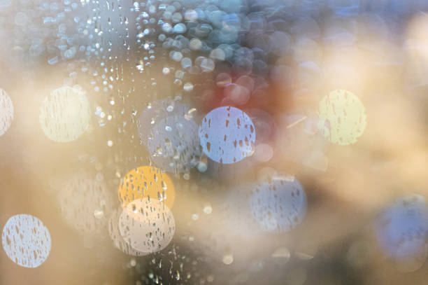 istock Close up Rain falling on window with traffic night light BG bokeh night 1424953266