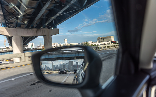 Going on a trip, a vacation dream. Reflection of downtown Miami in the side mirror. Goodbye Miami.